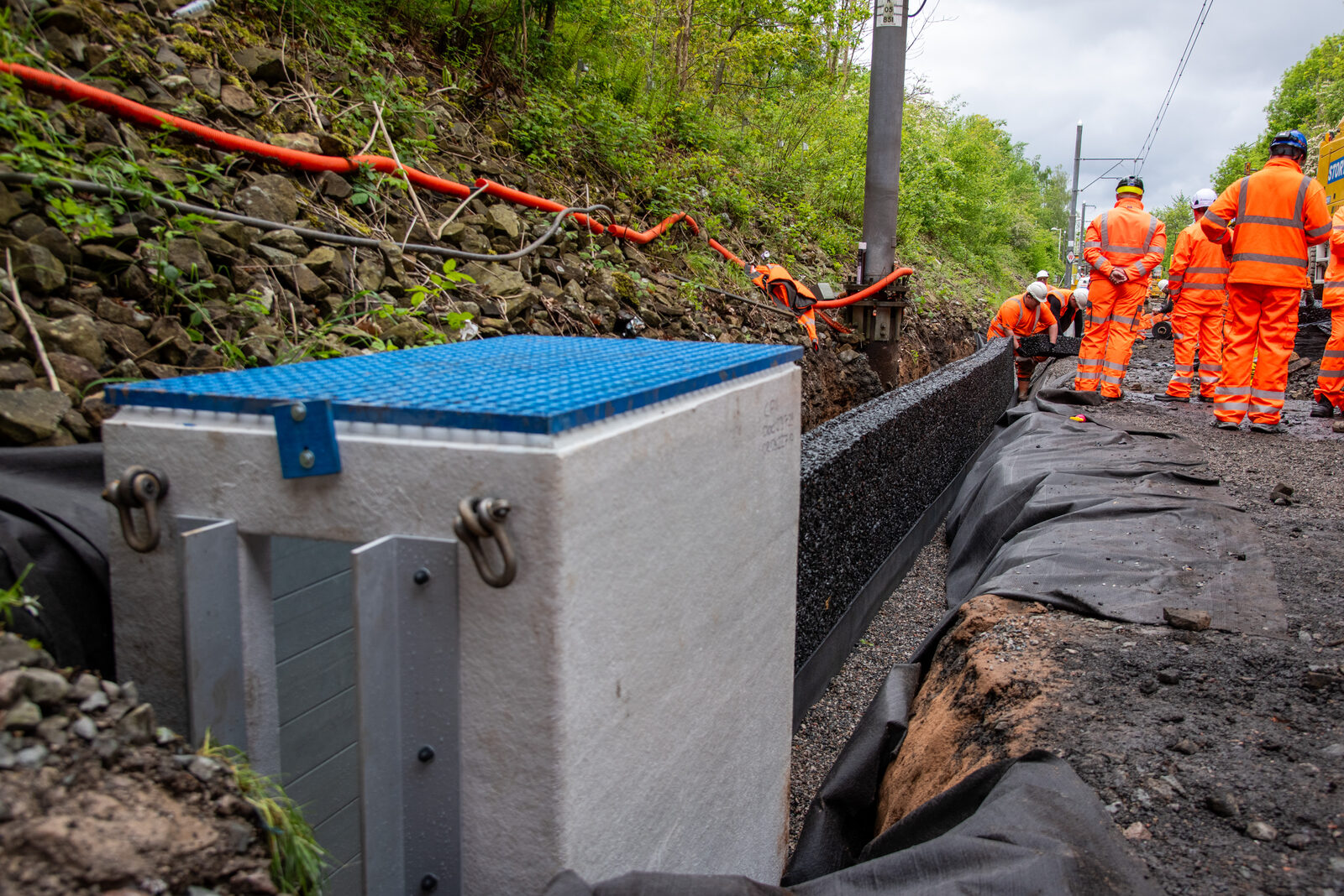 Long run of installed drainage modules with catchpit alongside the track